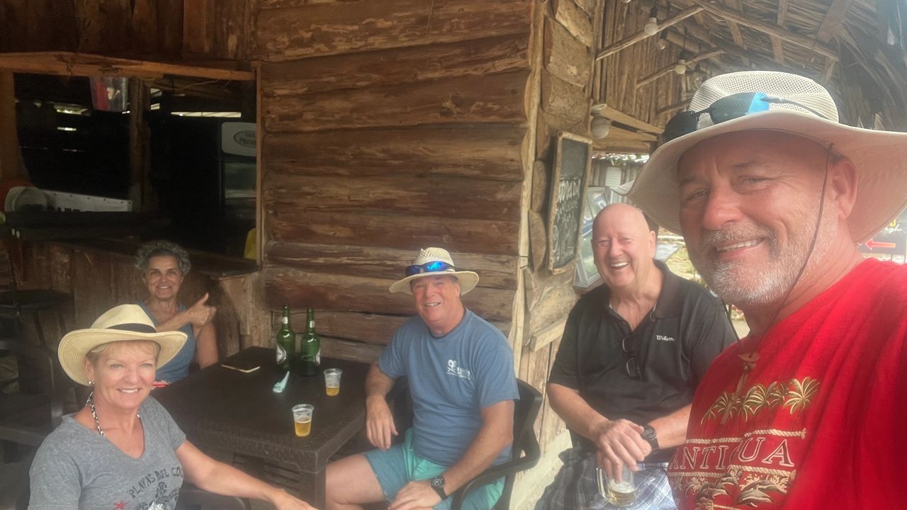 Waiting out the rain with a Presidente Beer