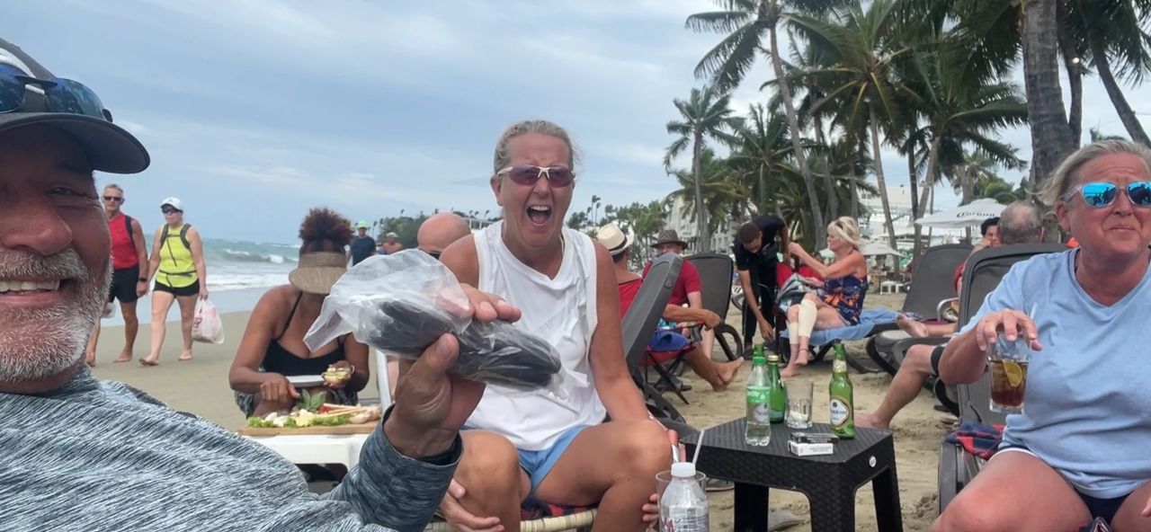 Buying Local grown Cocoa on the beach