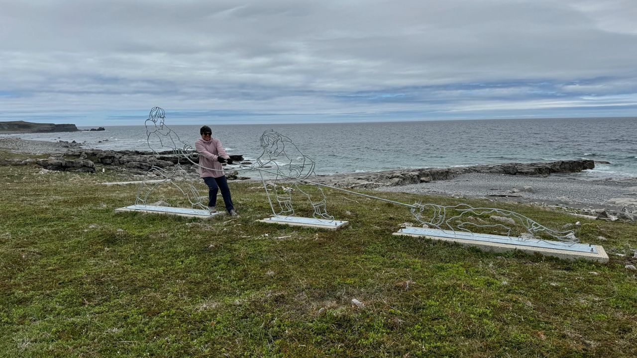 Yoli and Eskimos hauling in a seal